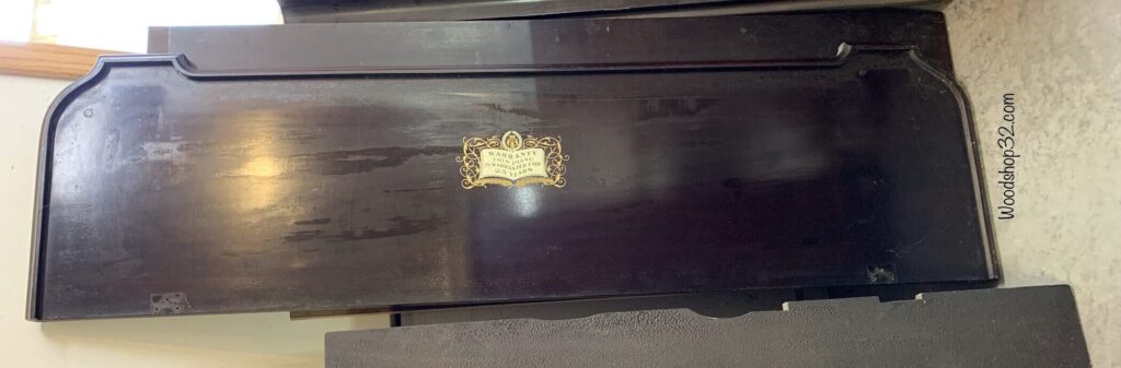 repurposed antique piano lid with label