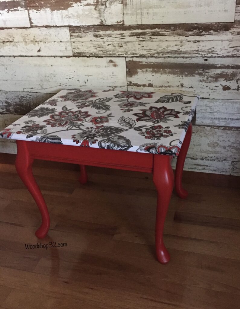 red painted end table with floral fabric