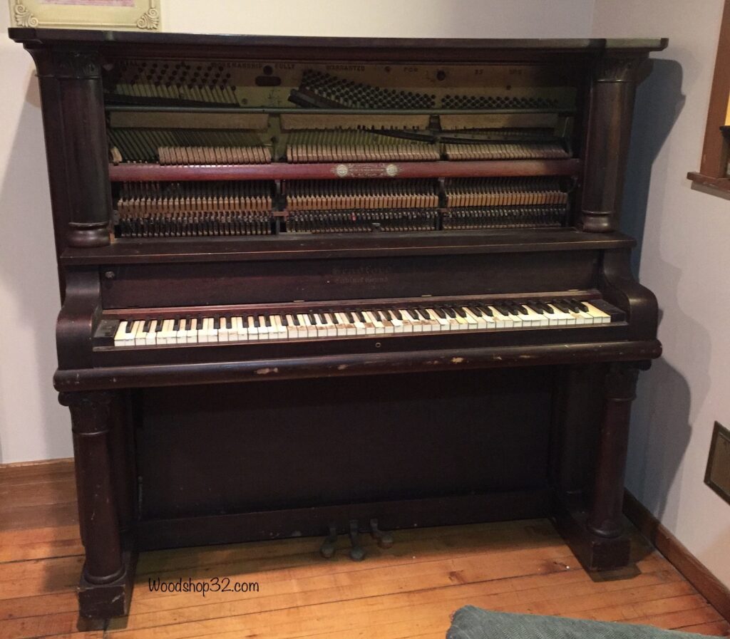 upright antique piano with front cover off