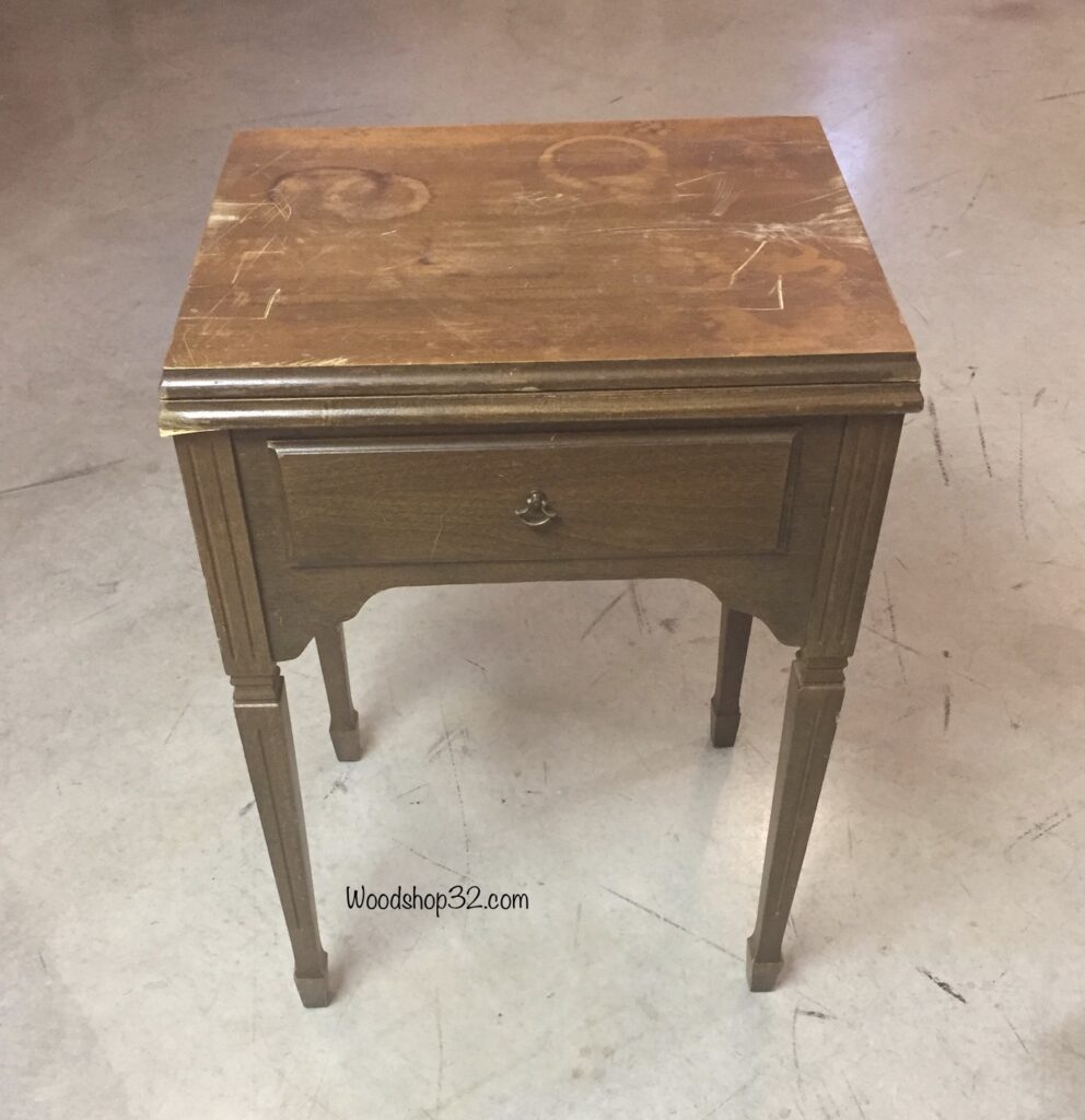 old sewing table with damaged top