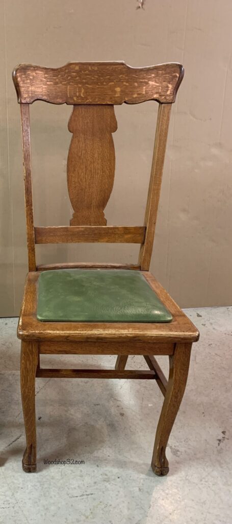 old wooden chair with seat pad