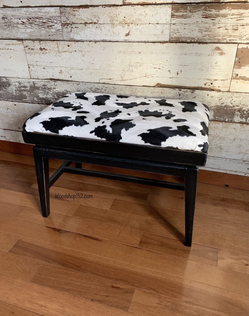 repurposed mid century modern ottoman with faux cow print