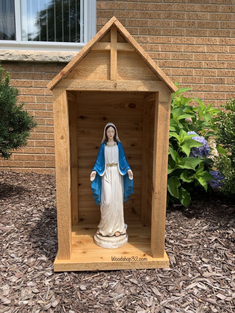 Blessed Holy Mary statue sits inside cedar garden shelter