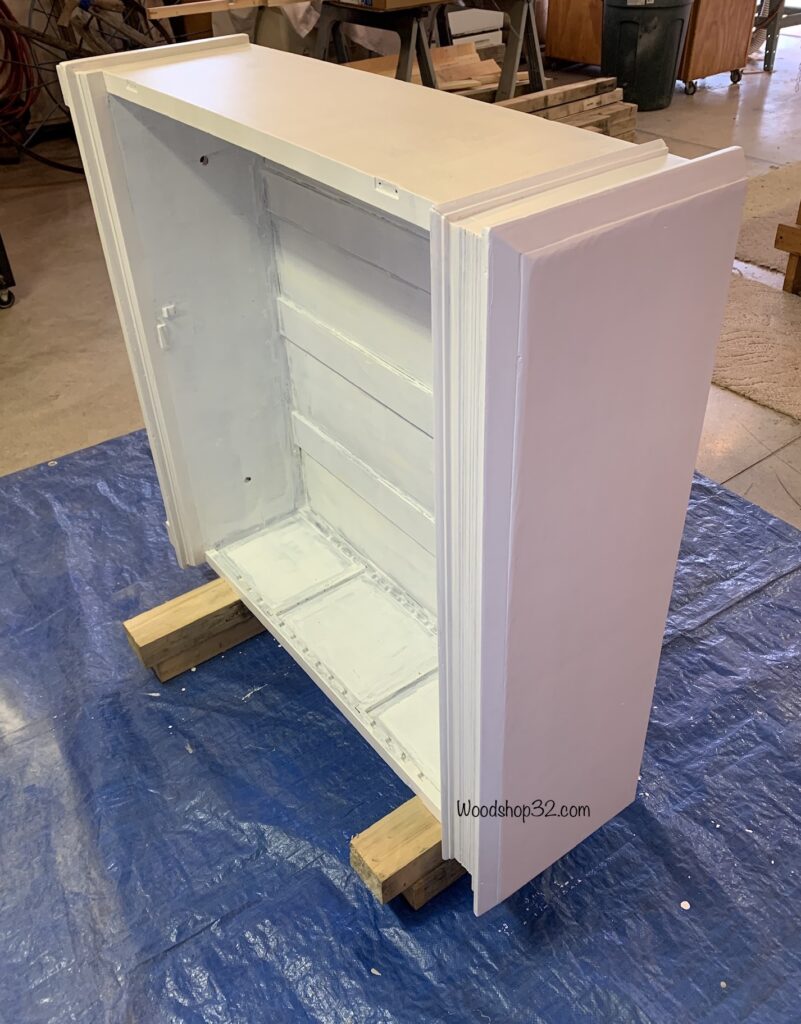 painting primer on vintage display cabinet