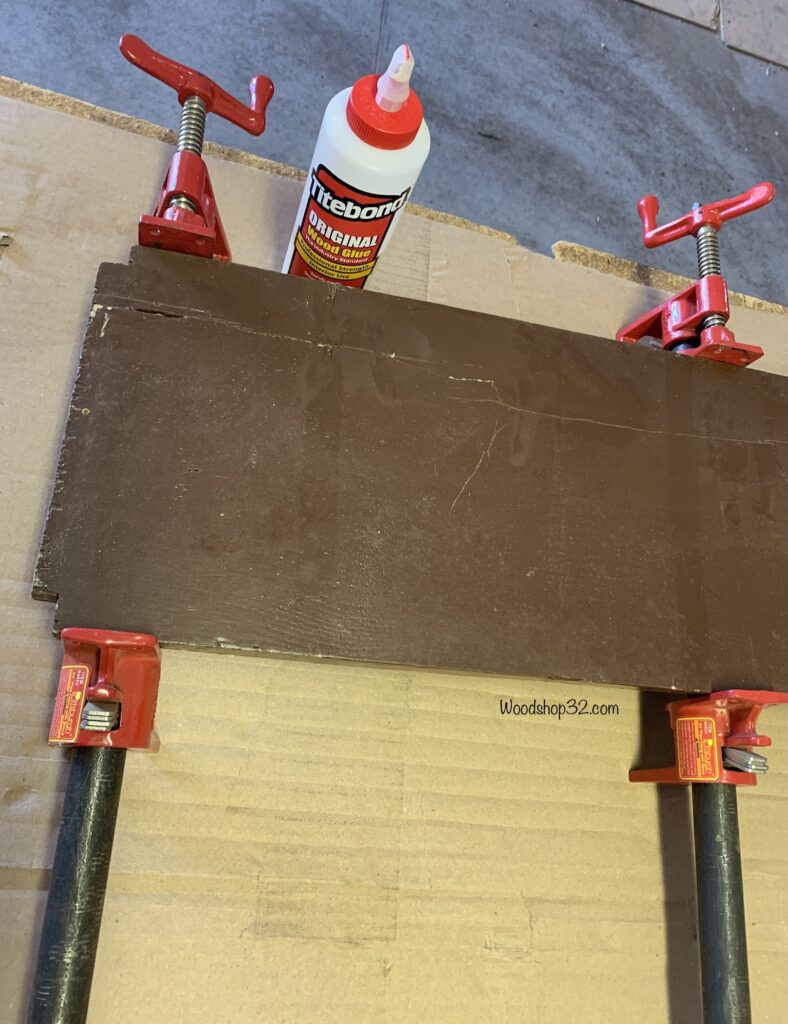 gluing vintage shelf and secure with pipe clamps