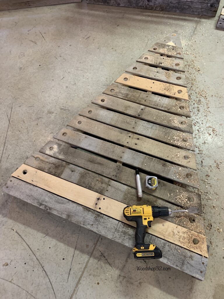DIY pallet Christmas tree drilling holes for lights